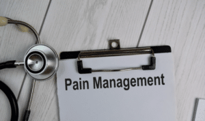 strethoscope, clipboard and text of pain management