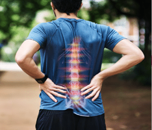 back of standing man placing hands on lower back