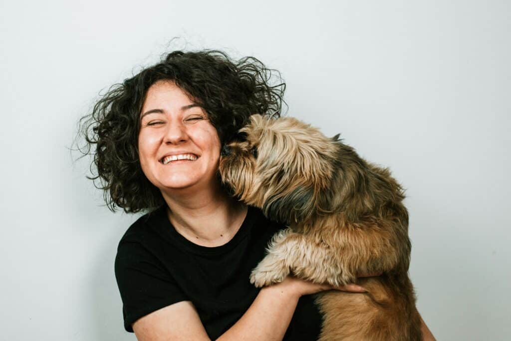 happy owner holding little dog