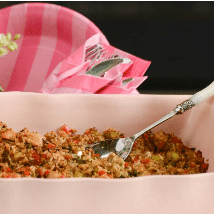 chicken and rice in a pink dish to pass